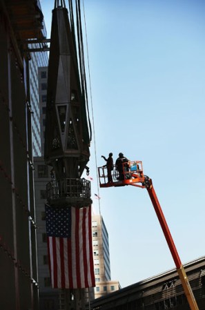 NEW YORK, NY - MAY 02: Workers fit supports to the final two sections of a 408-foot spire that will be hoisted to a temporary platform on the top of One World Trade Center on May 2, 2013 in New York City. When bolted into place at a later date, the spire will make One World Trade Center the tallest building in the Western Hemisphere.The raising of the spire, which comes on the second anniversary of the death of Osama bin Laden, will make One World Trade Center 1,776 feet tall. One World Trade Center is built on the site where the September 11, 2001 attacks toppled the original World Trade Center towers. (Photo by Spencer Platt/Getty Images)