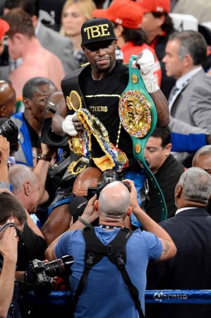 LAS VEGAS, NV - SEPTEMBER 14: Floyd Mayweather Jr. celebrates his majority decision victory against Canelo Alvarez in their WBC/WBA 154-pound title fight at the MGM Grand Garden Arena on September 14, 2013 in Las Vegas, Nevada. (Photo by Ethan Miller/Getty Images)