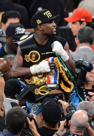 LAS VEGAS, NV - SEPTEMBER 14: Floyd Mayweather Jr. celebrates his majority-decision victory over Canelo Alvarez in their WBC/WBA 154-pound title fight at the MGM Grand Garden Arena on September 14, 2013 in Las Vegas, Nevada. (Photo by Ethan Miller/Getty Images)