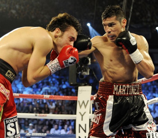 LAS VEGAS, NV - SEPTEMBER 15: Sergio Martinez (R) lands a right to the head of Julio Cesar Chavez Jr. in the fifth round of their WBC middleweight title fight at the Thomas & Mack Center on September 15, 2012 in Las Vegas, Nevada. (Photo by Jeff Bottari/Getty Images)