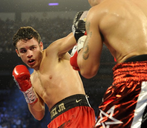 LAS VEGAS, NV - SEPTEMBER 15: Julio Cesar Chavez Jr. (L) blocks a punch from Sergio Martinez in the sixth round of their WBC middleweight title fight at the Thomas & Mack Center on September 15, 2012 in Las Vegas, Nevada. (Photo by Jeff Bottari/Getty Images)