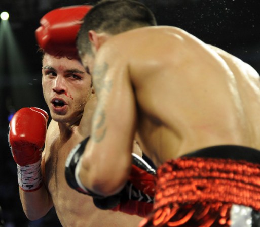 LAS VEGAS, NV - SEPTEMBER 15: Julio Cesar Chavez Jr. (L) and Sergio Martinez trade punches in the seventh round of their WBC middleweight title fight at the Thomas & Mack Center on September 15, 2012 in Las Vegas, Nevada. (Photo by Jeff Bottari/Getty Images)