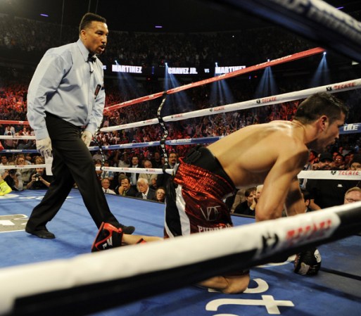 LAS VEGAS, NV - SEPTEMBER 15: Julio Cesar Chavez Jr. (L) is instructed to walk away by referee Tony Weeks after knocking down Sergio Martinez in the twelfth round of their WBC middleweight title fight at the Thomas & Mack Center on September 15, 2012 in Las Vegas, Nevada. (Photo by Jeff Bottari/Getty Images)