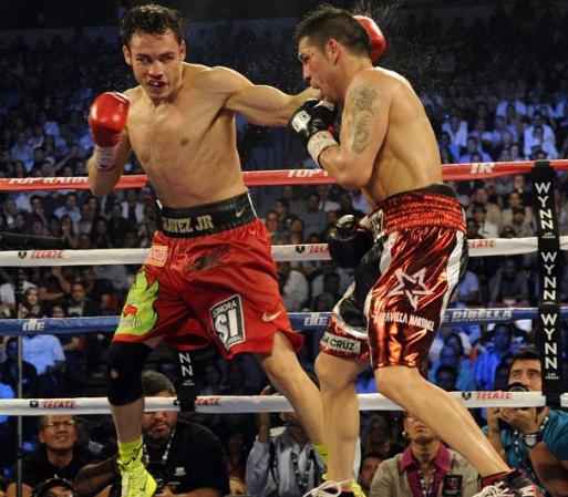 LAS VEGAS, NV - SEPTEMBER 15: Julio Cesar Chavez Jr. (L) lands a left to the head of Sergio Martinez in the twelfth round of their WBC middleweight title fight at the Thomas & Mack Center on September 15, 2012 in Las Vegas, Nevada. (Photo by Jeff Bottari/Getty Images)