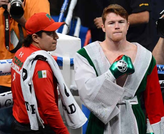 LAS VEGAS, NV - SEPTEMBER 14: Canelo Alvarez (R) and his co-trainer Eddy Reynoso enter the ring to take on Floyd Mayweather Jr. in their WBC/WBA 154-pound title fight at the MGM Grand Garden Arena on September 14, 2013 in Las Vegas, Nevada. (Photo by Ethan Miller/Getty Images)