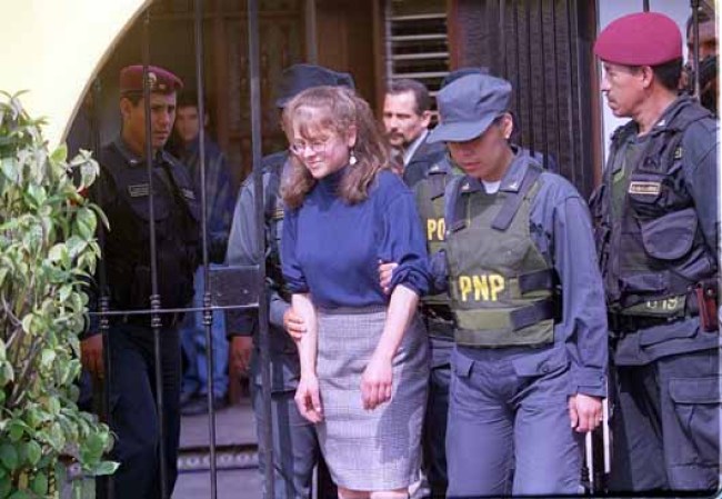 380630 02: American Lori Berenson, jailed in Peru on terrorism charges, is escorted to a house October 20, 2000 where she allegedly helped plot an attack on Congress, during a reenactment of events in Lima, Peru. Berenson was sentenced to life by a hooded military judge in 1996 for treason after being found guilty of being a leader of the Cuban-inspired Tupac Amaru Revolutionary Movement (MRTA) and plotting to attack the Peruvian Congress. Peruvian officials moved Berenson from Socabaya to a prison in Lima and said she would be granted a new trial by a civil court. (Photo by Newsmakers)