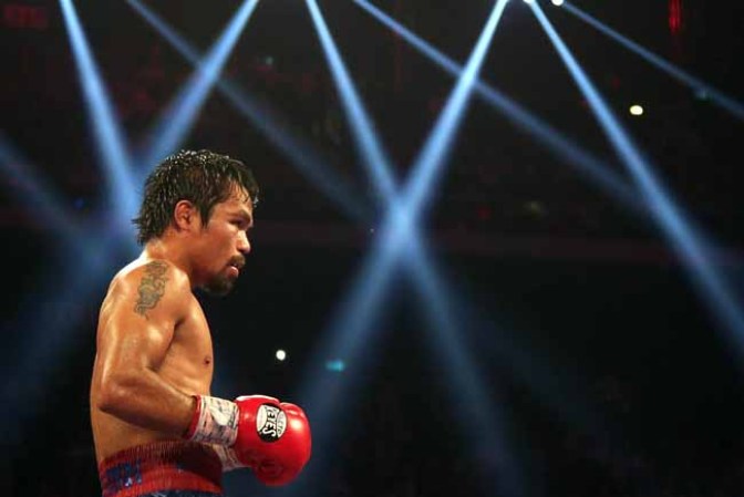 MACAU - NOVEMBER 24: Manny Pacquiao of the Philippines fights with Brandon Rios of the U.S. during their 'Clash in Cotai' WBO International Welterweight title bout on November 24, 2013 in Macau. (Photo by Nicky Loh/Getty Images)