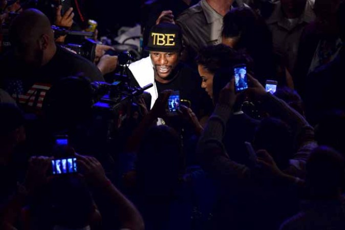 LAS VEGAS, NV - SEPTEMBER 14: Floyd Mayweather Jr. celebrates his majority decision victory against Canelo Alvarez in their WBC/WBA 154-pound title fight at the MGM Grand Garden Arena on September 14, 2013 in Las Vegas, Nevada. (Photo by Ethan Miller/Getty Images)