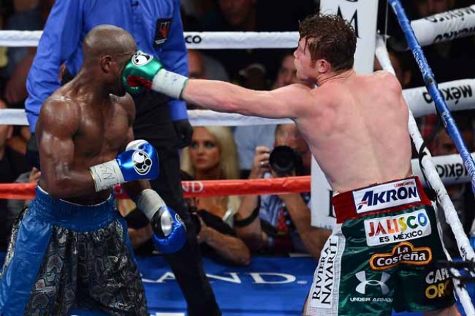 LAS VEGAS, NV - SEPTEMBER 14: (R-L) Canelo Alvarez throws a left at Floyd Mayweather Jr. during their WBC/WBA 154-pound title fight at the MGM Grand Garden Arena on September 14, 2013 in Las Vegas, Nevada. (Photo by Ethan Miller/Getty Images)
