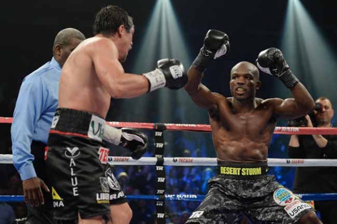 LAS VEGAS, NV - OCTOBER 12: WBO welterweight champion Timothy Bradley Jr. (R) taunts Juan Manuel Marquez during their bout at the Thomas & Mack Center on October 12, 2013 in Las Vegas, Nevada. Timothy Bradley Jr. wins in a split-decision victory over Juan Manuel Marquez. (Photo by Jeff Bottari/Getty Images)