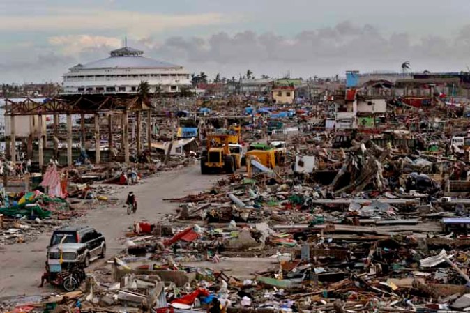 TACLOBAN, PHILIPPINES - NOVEMBER 13: An entire neighbourhood is destroyed in the aftermath of Typhoon Haiyan on November 13, 2013 in Tacloban, Leyte, Philippines. Typhoon Haiyan, packing maximum sustained winds of 195 mph (315 kph), slammed into the southern Philippines and left a trail of destruction in multiple provinces, forcing hundreds of thousands to evacuate and making travel by air and land to hard-hit provinces difficult. Around 10,000 people are feared dead in the strongest typhoon to hit the Philippines this year. (Photo by Kevin Frayer/Getty Images)
