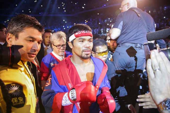 MACAU - NOVEMBER 24: Manny Pacquiao of the Philippines walks into the ring before his bout with Brandon Rios of the U.S. during their 'Clash in Cotai' WBO International Welterweight title fight on November 24, 2013 in Macau. (Photo by Nicky Loh/Getty Images)