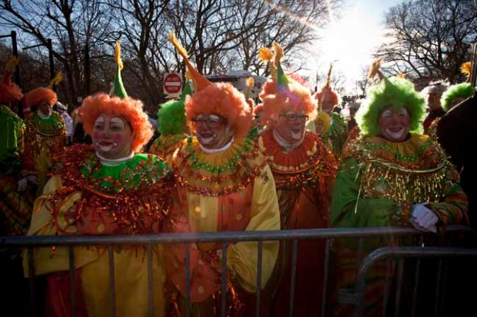 NEW YORK, NY - NOVEMBER 28: People dressed as clowns attend the Macy's Thanksgiving Day Parade on November 28, 2013 in New York City. Despite earlier concerns about the wind, the balloons flew as planned for the parade. (Photo by Kena Betancur/Getty Images)