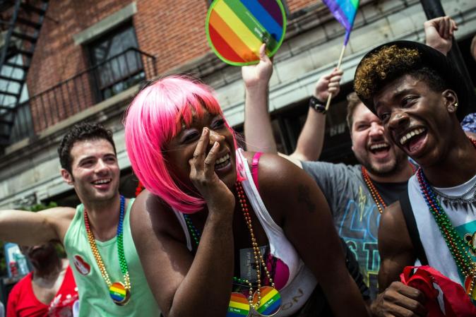 NEW YORK, NY - JUNE 30: Revelers watch the New York Gay Pride Parade on June 30, 2013 in New York City. This year's parade was a particularly festive occasion, due to the recent Supreme Court Ruling that it was unconstitutional to ban gay marriage. (Photo by Andrew Burton/Getty Images)
