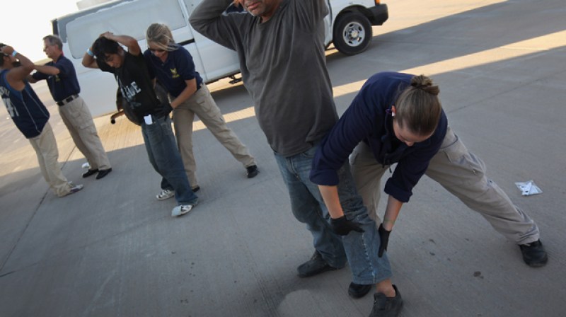 MESA, AZ - JUNE 24: Undocumented Guatemalan immigrants are body searched before boarding a deportation flight to Guatemala City, Guatemala at Phoenix-Mesa Gateway Airport on June 24, 2011 in Mesa, Arizona. The U.S. Immigration and Customs Enforcement agency, ICE, repatriates thousands of undocumented Guatemalans monthly, many of whom are caught in the controversial "Secure Communities" data-sharing program which puts local police on the frontlines of national immigration enforcement. ICE recently announced a set of adjustments to the federal program after many local communities and some states, including New York, insisted on opting out, saying immigrants were being deported for minor offenses such as traffic violations. Guatemala ranks only second to Mexico in the number of illegal immigrants deported from the United States. (Photo by John Moore/Getty Images)