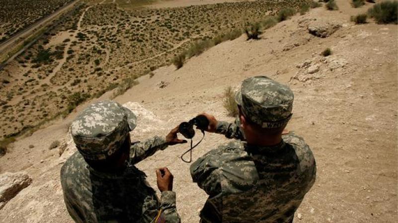 SUNLAND PARK, NEW MEXICO- JUNE 26: New Mexico National Guard Spec. Raymond Rivera (L) and Wyoming National Guard Spec. Scott Winters watch the US-Mexico border from a bluff June 26, 2007 near Sunland Park, New Mexico. The National Guard is participating in Operation Jumpstart, supporting the Border Patrol in protecting the border region. According to Majority Leader Harry Reid (D-NV), the Senate took a step closer to passing comprehensive immigration legislation today that could possibly grant 12 million people living in the United States "a pathway to legalization." (Photo by Chip Somodevilla/Getty Images) *** Local Caption *** Scott Winters;Raymond Rivera
