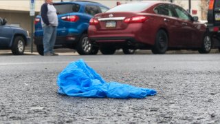 Disposable blue glove on the ground