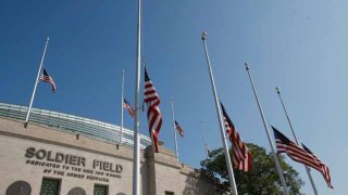 American Flags are flown at half mast outside Soldier Field