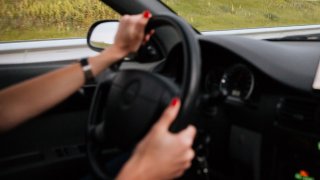 Woman driver driving car on the road