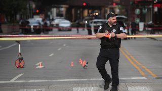 Police investigate where a shooting took place on Michigan Ave. hours after the city suffered from widespread looting and vandalism