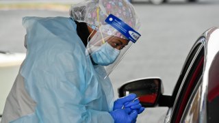 RN Treva Rivers administers a COVID-19 test
