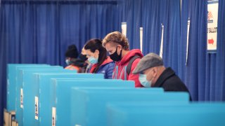 In this Oct. 2, 2020, file photo, residents vote at an early voting site in Chicago, Illinois.
