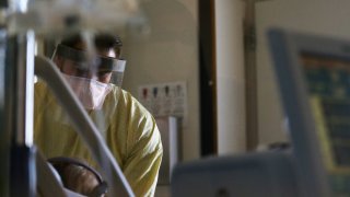 Registered nurse Eduardo Eran cares for a COVID-19 patient.