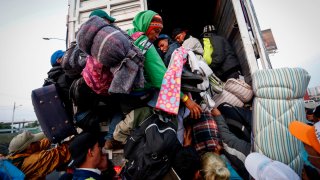 Migrantes bajan de un camión en el que cruzaban México