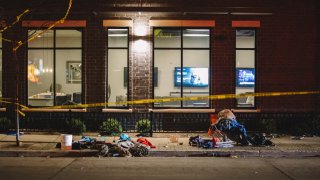 Debris litters a holiday parade route in Waukesha, Wisconsin, Nov. 21, 2021. An SUV plowed into parade performers Sunday afternoon, killing five and injuring 40 others.