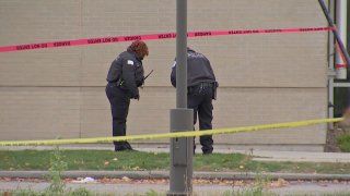 Chicago police set up evidence markers at the scene of a fatal shooting of an armored car guard in the Chatham neighborhood on Nov. 15, 2021.