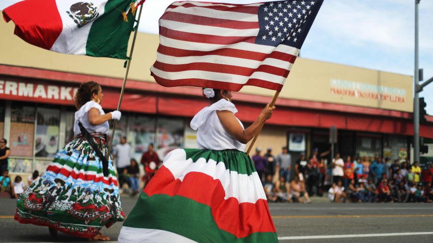 Performers carry the Mexican and U.S. flags during Santa Ana’s annual Fiestas Patrias parade on September 15, 2019 in Santa Ana, California. Fiestas Patrias marks Mexican Independence Day which officially falls tomorrow. The city of Santa Ana is approximately 78 percent Latino.