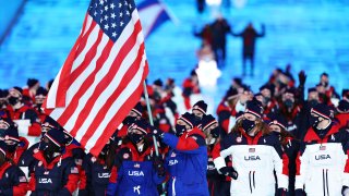 Flag bearers Brittany Bowe and John Shuster of Team USA lead the team during the Opening Ceremony of the Beijing 2022 Winter Olympics at the Beijing National Stadium on Feb. 4, 2022 in Beijing, China.