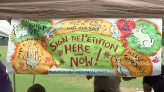 letrero de firma de peticion en Douglass Park