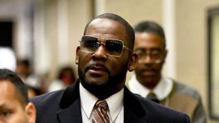 FILE - Musician R. Kelly, center, leaves the Daley Center after a hearing in his child support case on May 8, 2019, in Chicago.