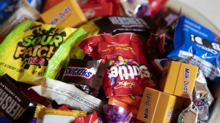Various Halloween candies in a bucket