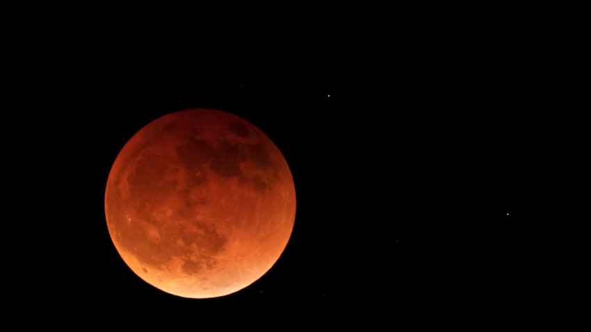 The moon is shown during a full lunar eclipse