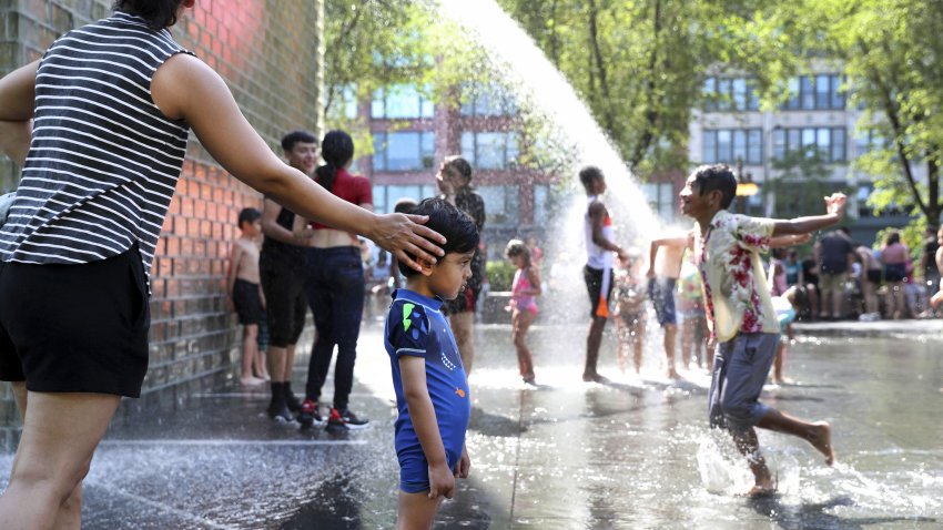 Anchal Khanna of Chicago&apos;s Lakeview neighborhood touches her son Veer Roy as the 2-year-old considers the landscape of Millennium Park&apos;s Crown Fountain during a heat wave on June 14, 2022. (Chris Sweda/Chicago Tribune/Tribune News Service via Getty Images)