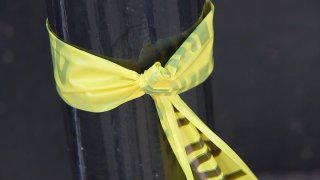 Police tape wrapped around pole