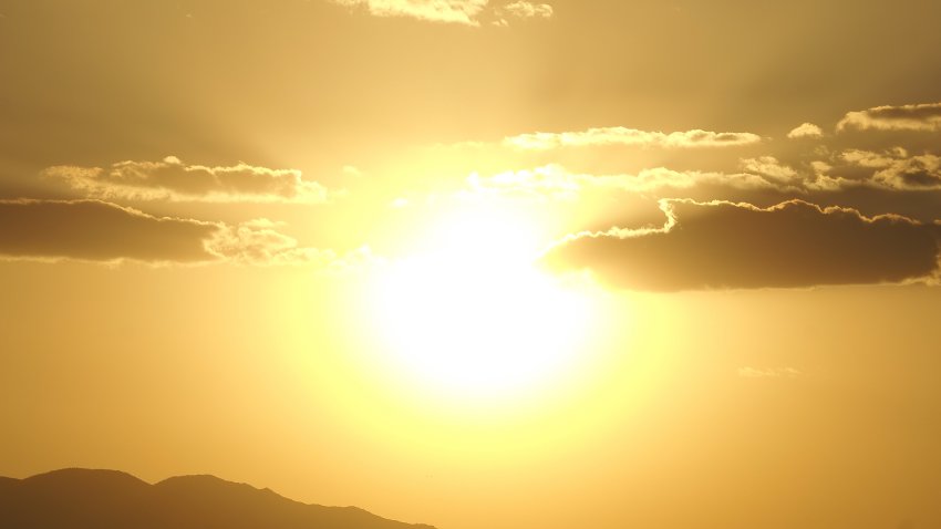 A magnificent composition of the blazing Sun bursting with light over The Sonoran Desert of Phoenix Arizona USA.