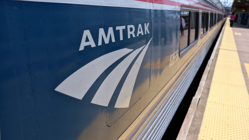 New Haven, Connecticut – May 18 2023: Amtrak logo on the side of a train stopped at a station in connecticut.  Vermonter trains switch engines from electric to diesel at the New Haven stop.