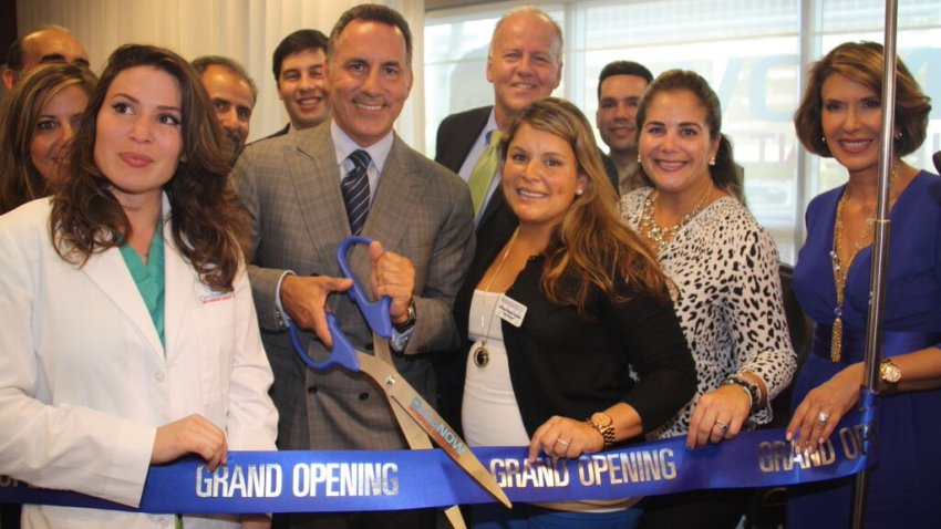 Dr. Alejandro Badia holding a pair of large scissors