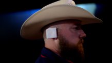 A delegate wears an imitation ear bandage during the Republican National Convention (RNC) at the Fiserv Forum in Milwaukee, Wisconsin, US, on Wednesday, July 17, 2024. The RNC chairman warned against complacency when his party concludes its official nominating jamboree this week with polls predicting ex-President Donald Trump prevailing over President Joe Biden in the November election. Photographer: Victor J. Blue/Bloomberg via Getty Images