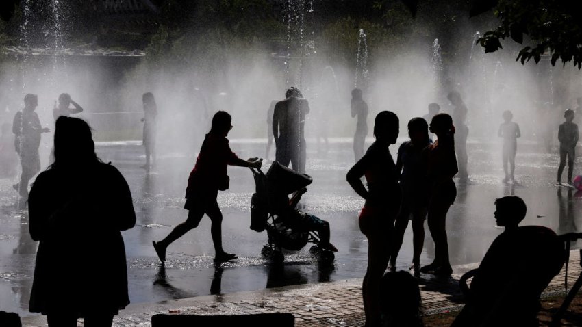 People cool off at a fountain in the Madrid Rio park amid heatwave conditions in Madrid on July 23, 2024. July 21, 2024 was the hottest day ever registered globally, according to preliminary data published on July 23, 2024 by the EU’s climate monitor. The Copernicus Climate Change Service (C3S) said the global average surface air temperature on July 21 was 17.09 degrees Celsius, a fraction above the previous record set in 2023. (Photo by OSCAR DEL POZO / AFP) (Photo by OSCAR DEL POZO/AFP via Getty Images)