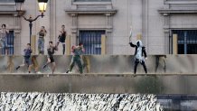 PARIS, FRANCE - JULY 26: Dancers perform on the banks of the river Seine during the Opening Ceremony of the Olympic Games Paris 2024 on July 26, 2024 in Paris, France. (Photo by Jack Guez - Pool/Getty Images)