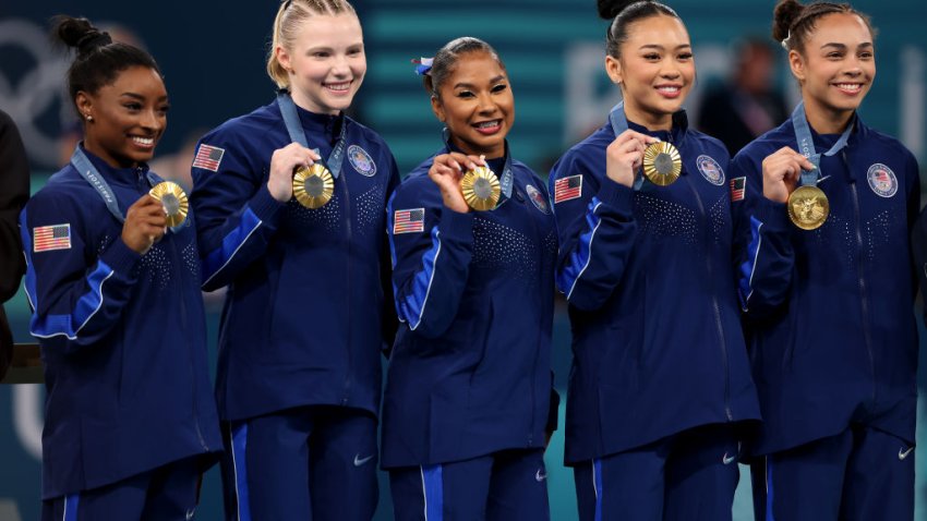 PARIS, FRANCE – JULY 30: (L-R) Simone Biles, Jade Carey, Jordan Chiles, Sunisa Lee and Hezly Rivera of Team United States celebrate on the podium during the medal ceremony for the Artistic Gymnastics Women’s Team Final on day four of the Olympic Games Paris 2024 at Bercy Arena on July 30, 2024 in Paris, France. (Photo by Jamie Squire/Getty Images)