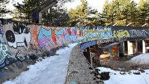 The partially dismantled bobsleigh track which was damaged during past conflicts lies abandoned on Mount Trevevic, near Sarajevo on February 6, 2024, as Sarajevo begins marking the 40th anniversary of the XIV Winter Olympics. The track was built 40 years ago as one of the Olympic venues during Sarajevo's XIV Winter Olympics in 1984. The venue has never been used for official competition since. Four decades after Bosnia's capital Sarajevo hosted the Winter Olympics, residents remember the event with a mixture of pride and melancholy that marked one of the last unifying moments in Yugoslavia before war destroyed the country. Most of the Olympics infrastructure was destroyed during the war that raged from 1992 to 1995, with Bosnia Serb political leaders and fighters commandeering a hotel during the siege of Sarajevo that once hosted tourists at the games. The stunning reversal of the city's fortunes remains a bittersweet wound for residents with living memories of both the Olympics and the war that followed. (Photo by ELVIS BARUKCIC / AFP) (Photo by ELVIS BARUKCIC/AFP via Getty Images)