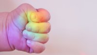 Closed Human Hand with colors of the rainbow