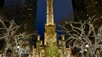 Water Tower in Chicago on Milwaukee Ave., decorated for Christmas Time with people gathered around