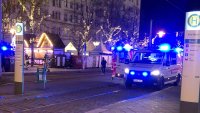 Police vehicle outside German Christmas market.