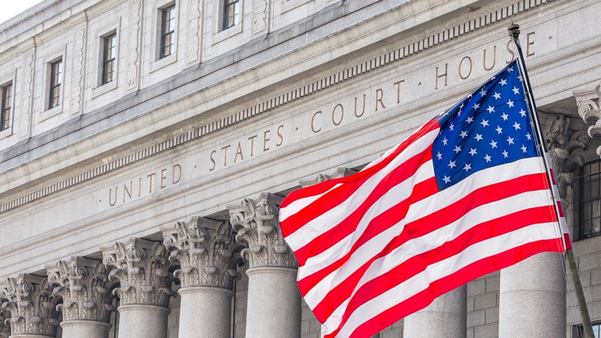 USA national flag waving in the wind in front of United States Court House in New York